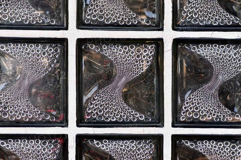 Textured translucent glass block wall with curved circular pattern