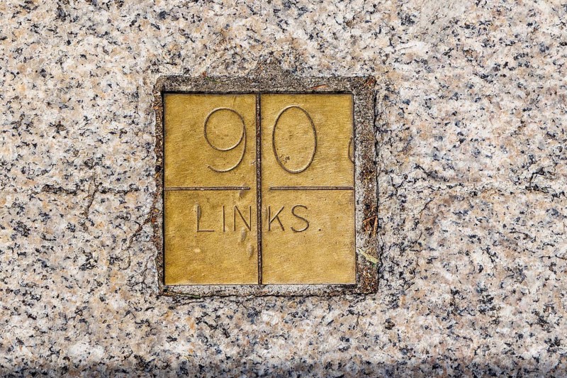 A brass plaque marked 90 links forms part of the Imperial Standards of Length set into the wall and stairs of Trafalgar Square. Installed in 1876 by the Board of Trade, the scale let land surveyors check equipment against Britain's official standard. London, England, United Kingdom