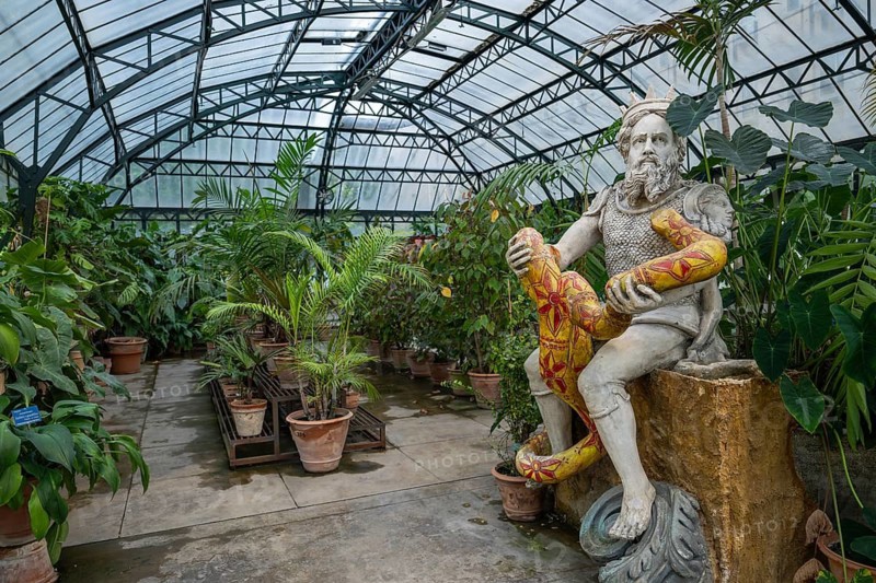 Genius of Palermo or Genio di Palermo, patron saint of the city of Palermo, modern sculpture by Domenico Pellgrino, interior view of a large greenhouse, Palermo Botanical Garden or Orto Botanico, Palermo, Sicily, Italy