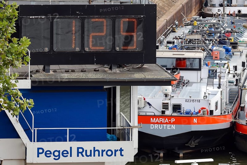Duisburg, North Rhine-Westphalia, Germany - Low tide on the Rhine. Today, on 16.08.2026, it is only 1.29 meters away at the Ruhrort level. Because of the draft, freighters can only sail the Rhine with little load. After a long drought, the Rhine level continues to fall