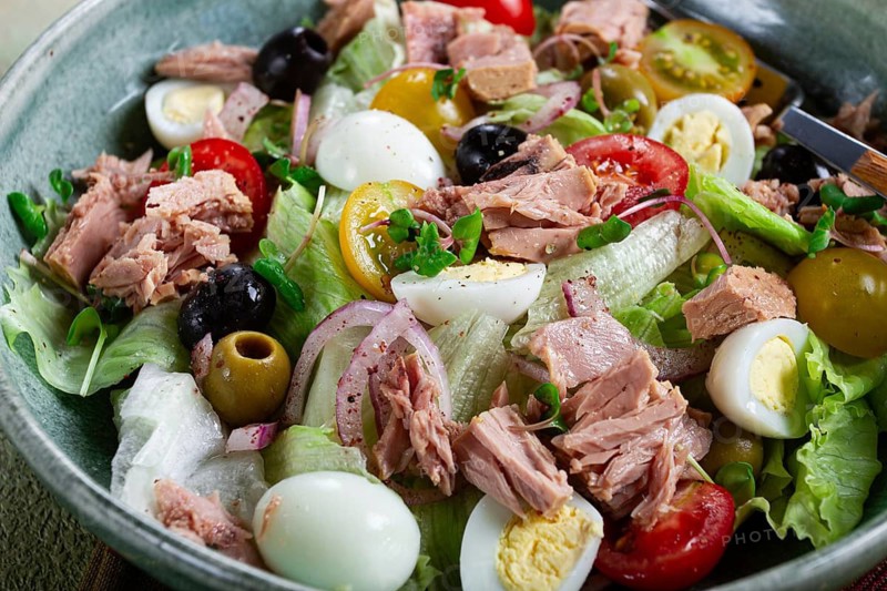 Salad with canned tuna, vegetable salad with quail eggs, lettuce, red onion, cherry tomatoes, olives, keto food, healthy food, homemade, no people