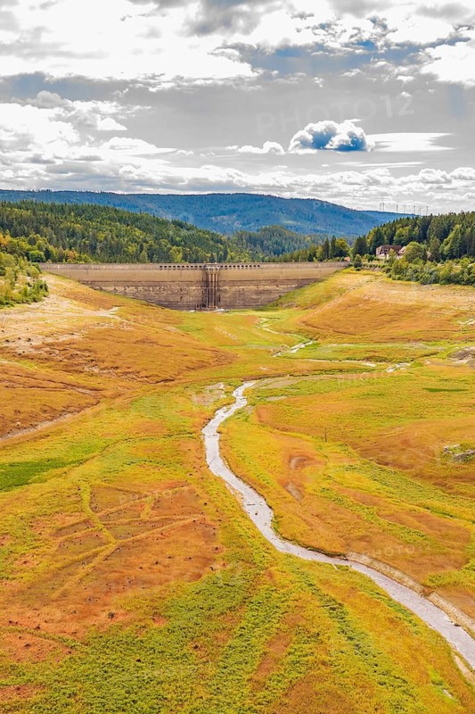 A dry valley with a dam in the background and a narrow river through the meadows, rehabilitation of the Schwarzenbach dam, Forbach, Black Forest, Germany