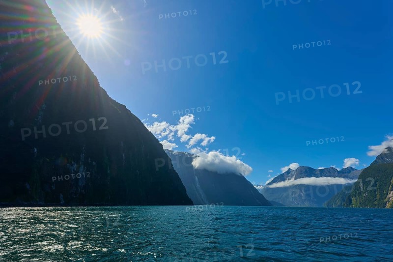 Sunny scene with blue waters and dramatic mountain ranges, summer, Milford Sound, Te Anau, Fiordland National Park, South Island, New Zealand