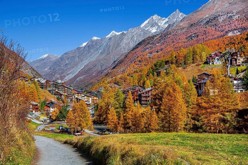 Autumn landscape with hiking trail and view of the village and dome 4545m of the Mischabel group, Zermatt, Mattertal, Valais, Switzerland