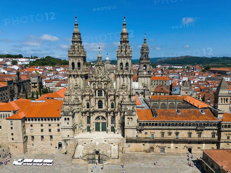 The aerial view shows an imposing cathedral with red roofs and historical flair under a blue sky, Cathedral, Santiago de Compostela, autonomous community of Galicia, place of pilgrimage, destination of the Way of St James, Spain