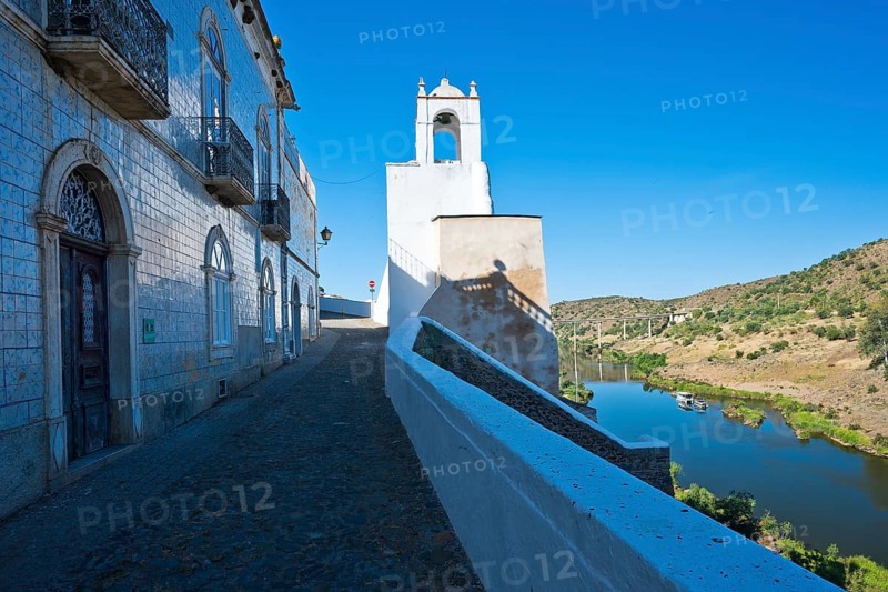 View of the clock tower (Torre do Relógio), which was built into one of the towers of the city walls on the right bank of the River Guadiana. Mertola. Baixo Alentejo. Portugal