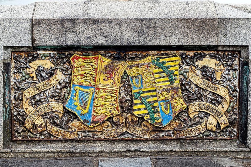 A brightly enamelled coat of arms panel forms part of the Victorian ornamentation on Westminster Bridge, opened in its present form in 1862. Heraldry linked to Queen Victoria and Prince Albert decorates the bridge, tying its Gothic design to the monarchy and Westminster, London, England, United Kingdom