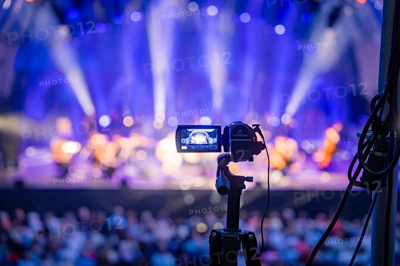 Camera on stand films a brightly lit concert stage, Calwer Klostersommer Festival, Hirsau Abbey, Calw, Germany