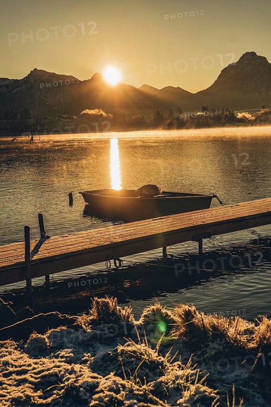 Frosty morning atmosphere during sunrise at Lake Hopfensee in the Allgäu in Bavaria, Germany