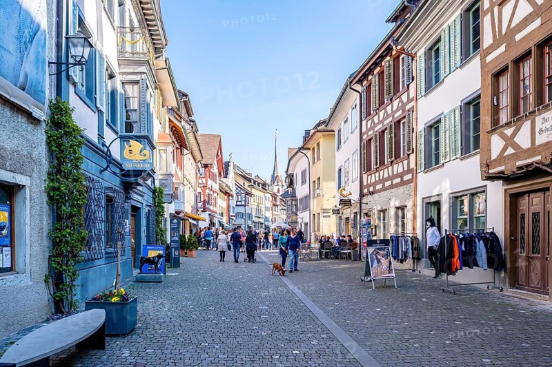 Busy old town street with half-timbered houses, cafés and shops on a sunny day, Stein am Rhein, Canton of Schaffhausen, Switzerland