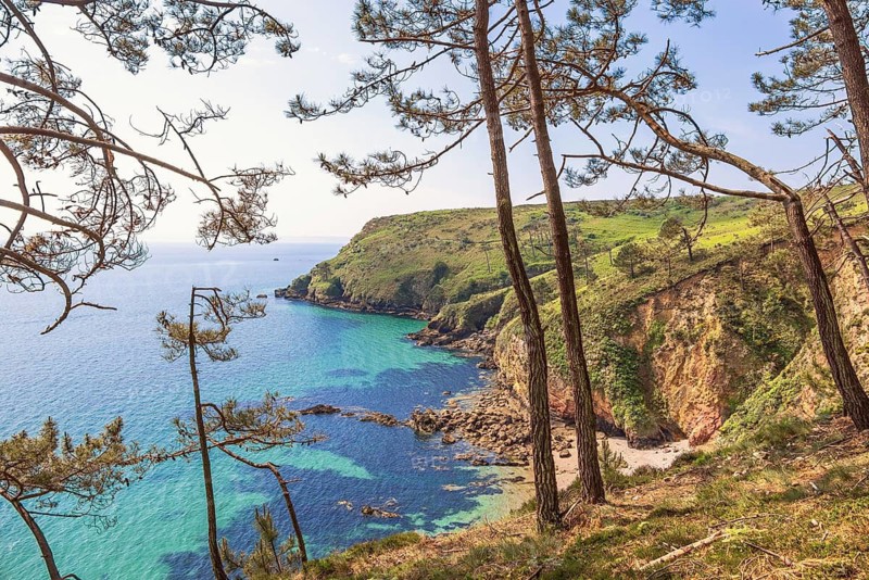 Scenics view at a rocky coast landscape with a sea view and a bay a sunny spring day from a pine woodland, Crozon peninsula, Bretagne, France