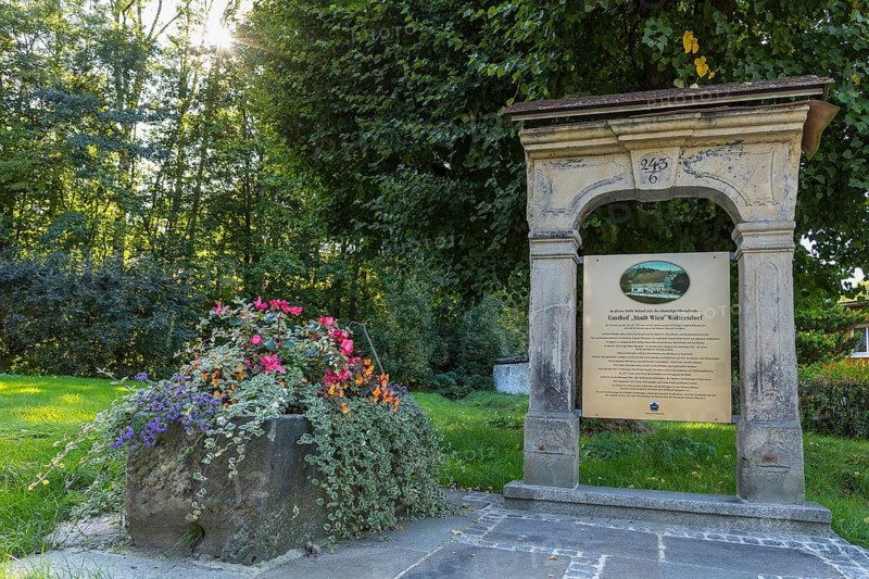 Historic sandstone portal and commemorative plaque at the old location of the former Oberschenke Gasthof Stadt Wien in Waltersdorf, Großschönau, Saxony, Germany
