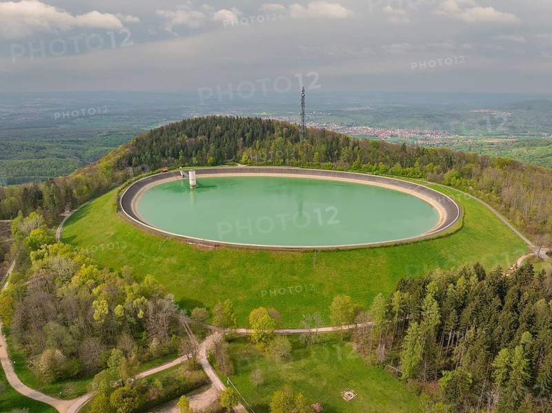 Upper reservoir, aerial view shows large round reservoir surrounded by forest and landscape, Glems reservoir, Swabian Alb, Germany