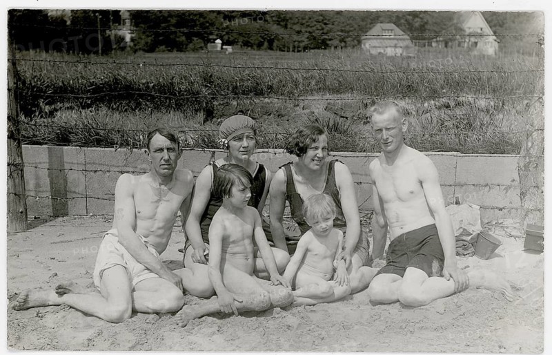 Bathing, swimwear, woman, men, children, leisure, fun, summer, family with two children sitting in the sand on the beach in sunny weather, around 1925