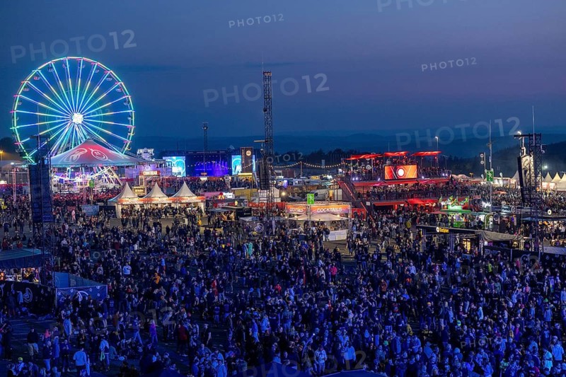 Adenau, Germany, 7 June 2024: Fans enjoy the Rock am Ring Festival during the blue hour. The festival takes place at the Nürburgring race track near the town of Adenau from 7 to 9 June 2024