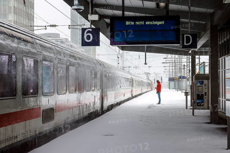 Essen, North Rhine-Westphalia, Germany - Onset of winter in the Ruhr area, Essen railway station, many trains are delayed or cancelled due to ice and snow, passenger waiting for train