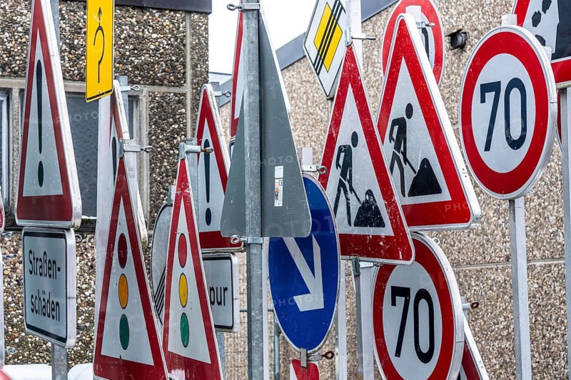 Storage for traffic signs in the yard of a road maintenance department, various signs with commandments and prohibitions, information about dangers, road traffic