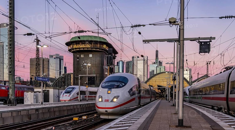 Frankfurt main station with ICE in the evening, sunset. View of platform and banking district, skyline of Frankfurt am Main, Hesse, Germany