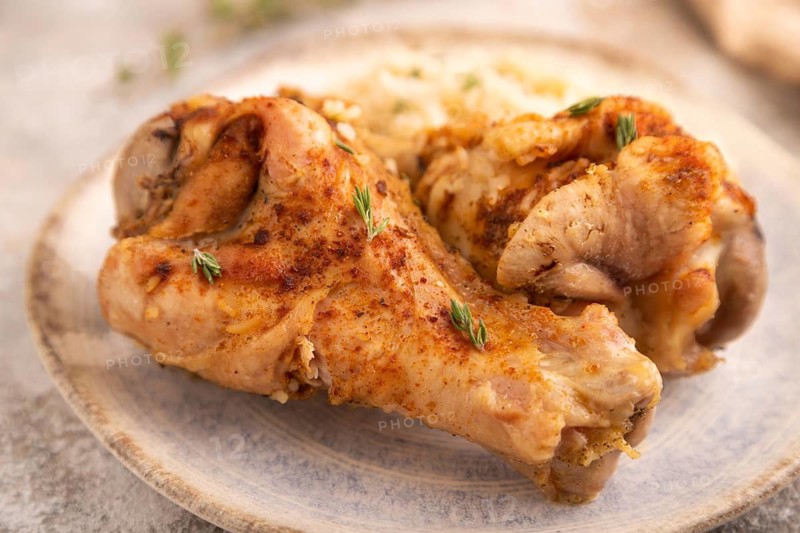 Fried Turkey Wing with spices and rice on brown concrete background and linen textile. side view, close up, selective focus