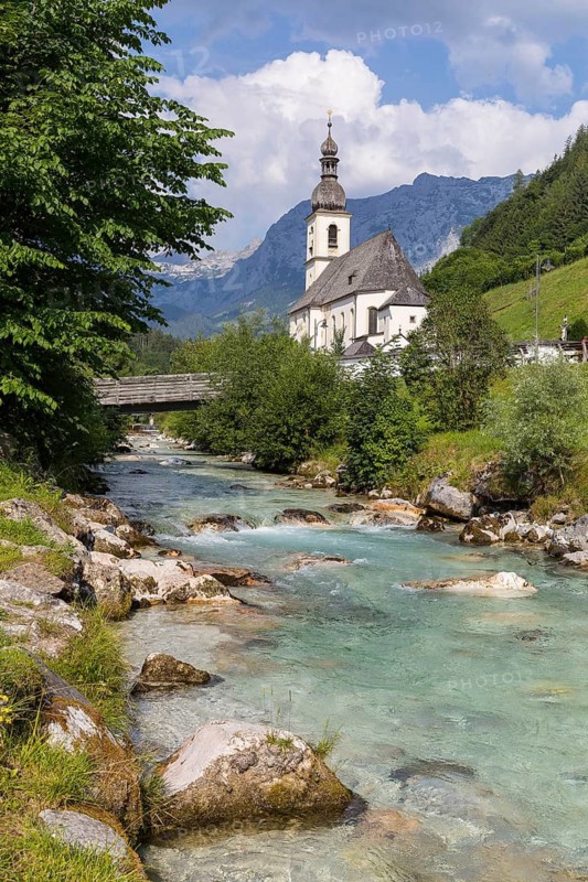 Famous view of the parish church of St. Sebastian with bridge over the Ramsauer Ache in the Ramsauer Malerwinkel with horse-rider Alm and Wagendrischelhorn, Ramsau near Berchtesgaden, Berchtesgadener Land, Bavaria, Germany