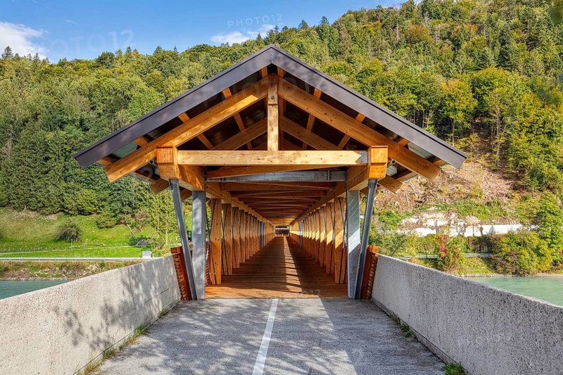 Wooden bridge over a river, surrounded by forests and mountains, in sunny weather, Innsteg, bridge over the Inn