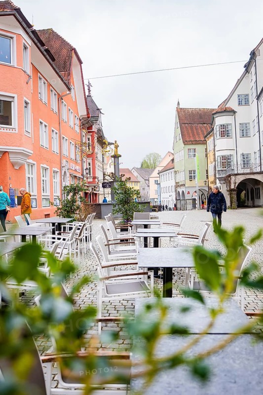 Street café with empty tables and half-timbered houses in an idyllic city scenario, Isny, Allgäu, Bavaria, Germany