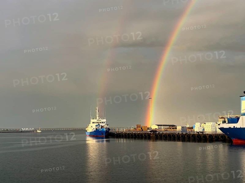 Harbour with ship and double rainbow in the sky over calm water, Kalmar, Kalmar Län, Sweden