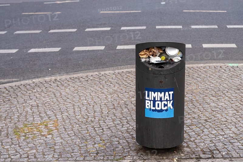 Overfilled paper and trash can at Tauentzien in Berlin, Germany