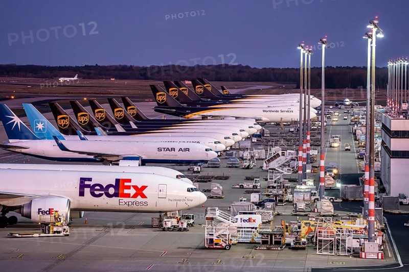 Cologne-Bonn airport, CGN, air freight center, UPS Logisic Hub, UPS cargo aircraft on the apron, FedEx and Star Air Cargo aircraft, Maersk, at the logistics center, in the evening