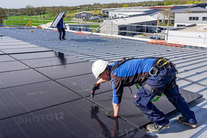 Installation of solar modules on the roof of a commercial enterprise, over 400 photovoltaic modules are installed on the roof, North Rhine-Westphalia, Germany