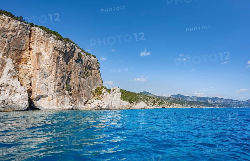 Picturesque rocky coast, cliffs and blue sea, Golfo di Orosei, Baunei, Sardinia, Italy