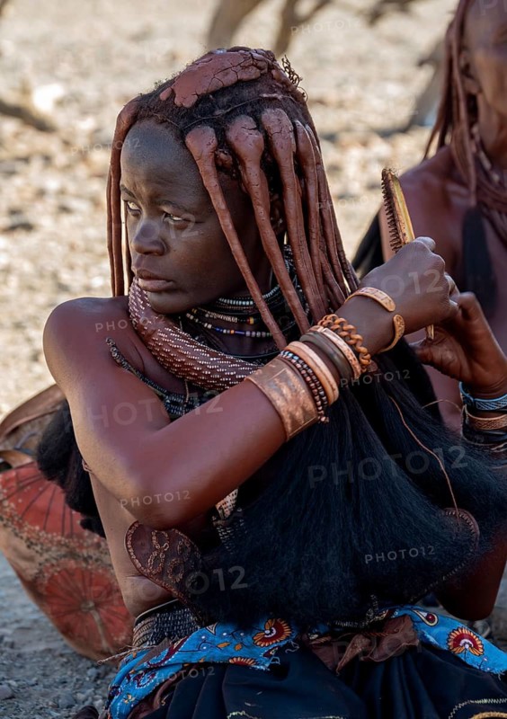 Himba woman combing her hair, near Opuwo, Kaokoveld, Kunene, Namibia