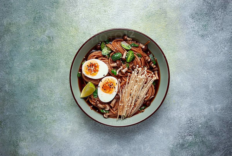 Soba, buckwheat noodles, with enoki mushrooms, shimeji and boiled egg, top view, homemade, no people