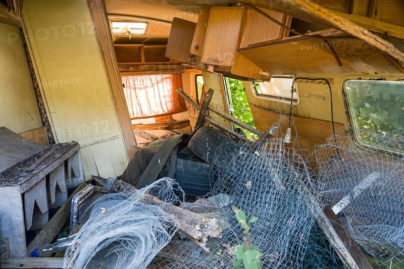 Parked rotten trailer, abandoned caravan on a pasture, Germany