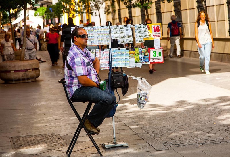Lottery ticket seller in Velazquez street a busy shopping in central Seville, Spain