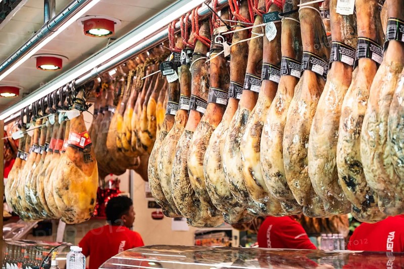 Ham at a market stall at La Boqueria market in Barcelona, Spain