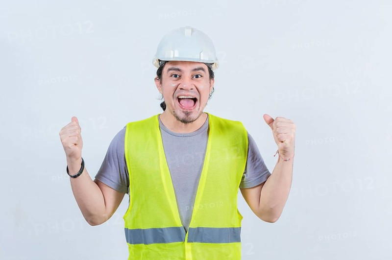 Happy engineer celebrating on isolated background. Excited engineer gesturing celebration isolated