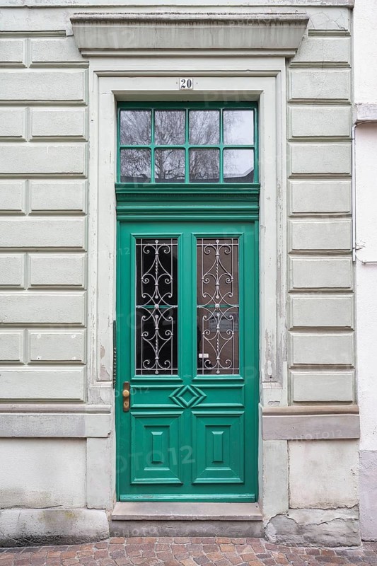 An elegant green door with decorative windows on a classic building in the historic old town of Constance, traditional craftsmanship, Konstanz district, Baden-Württemberg, Germany