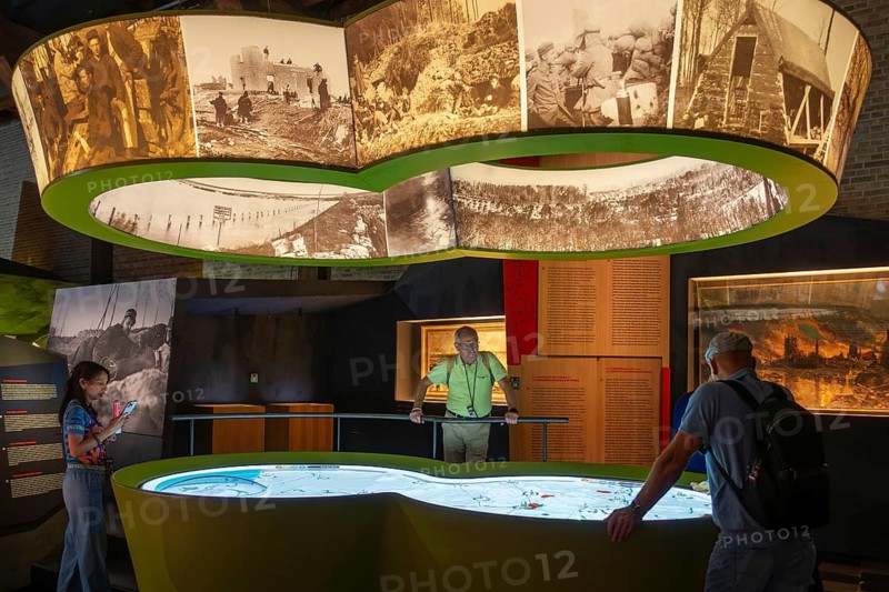 Visitors looking at map in the In Flanders Fields Museum about World War One at Ypres, Ieper, West Flanders, Belgium