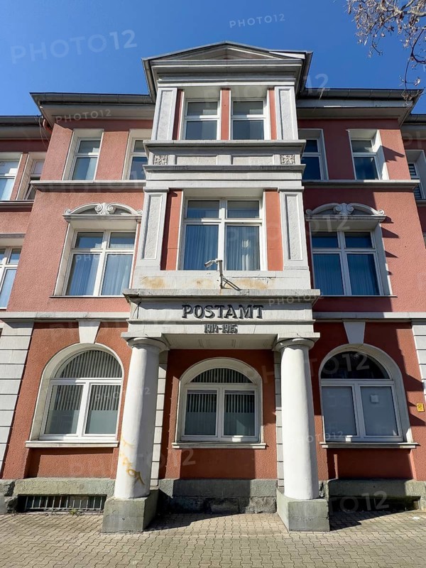 Historic building with representative façade of former post office during the German Empire with dates 1914-1915 in today's residential building on Bürer Straße in Gelsenkirchen-Horst, Gelsenkirchen, North Rhine-Westphalia, Germany