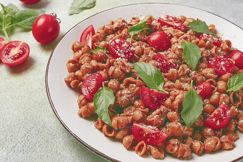 Tuscan pasta with smoked paprika and basil, parmesan cheese, Italian traditional cuisine