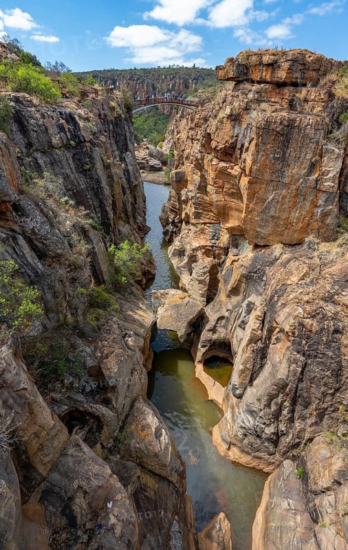 Bridge over a canyon with steep orange-coloured cliffs and the Blyde River, Bourke's Luck Potholes, Panorama Route, Mpumalanga, South Africa