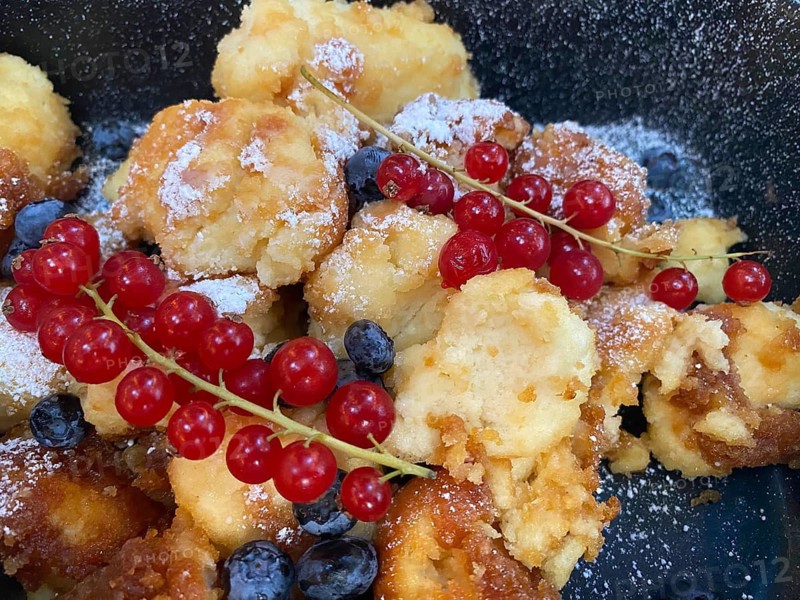 Caramelized Kaiserschmarrn, blueberries, currants, powdered sugar, on plate, food, Munich, Bavaria, Germany