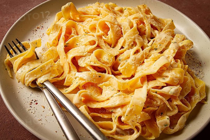 Fettuccine, tagliatelle, in creamy garlic sauce, Italian traditional cuisine, pasta carbonaro