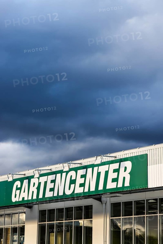 Mülheim, North Rhine-Westphalia, Germany - Garden centre, lettering on the facade in front of a dark stormy sky