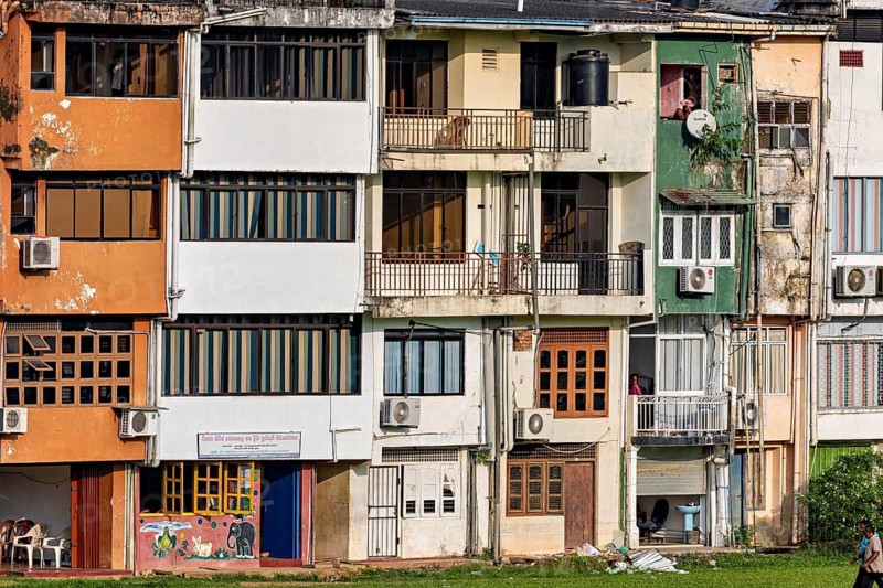 Nested house facades with air conditioners and colorful color accents in urban space, A house façade in Ratnapura in Sri Lanka