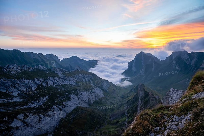 View over Säntis mountains into the valley of Meglisalp at sunrise, high fog in the valley, Säntis, Appenzell Ausserrhoden, Appenzell Alps, Switzerland