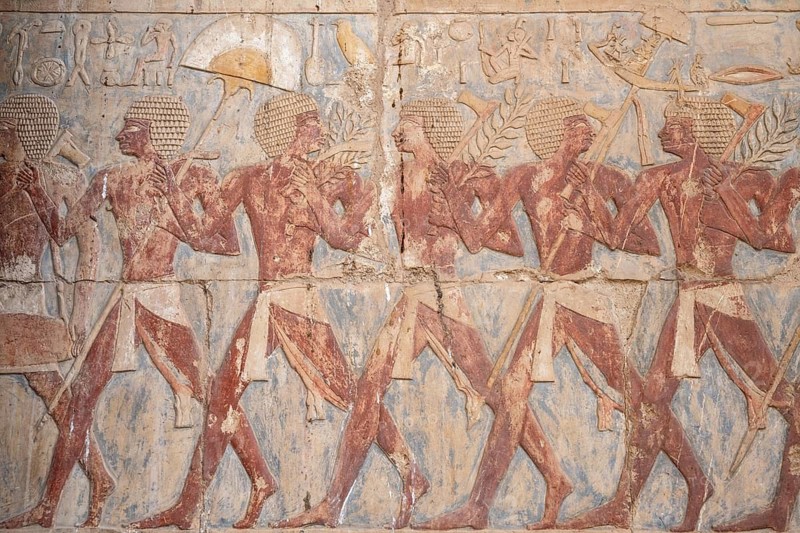 Ancient Egyptian art and inscriptions depicting the daily life and ceremonies of the Pharaoh kings at the historical Temple of Hatshepsut, Deir el-Bahari, Luxor, Egypt