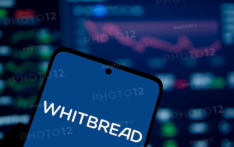 Whitbread logo is displayed on smartphone. Whitbread is a British multinational hotel and restaurant company.