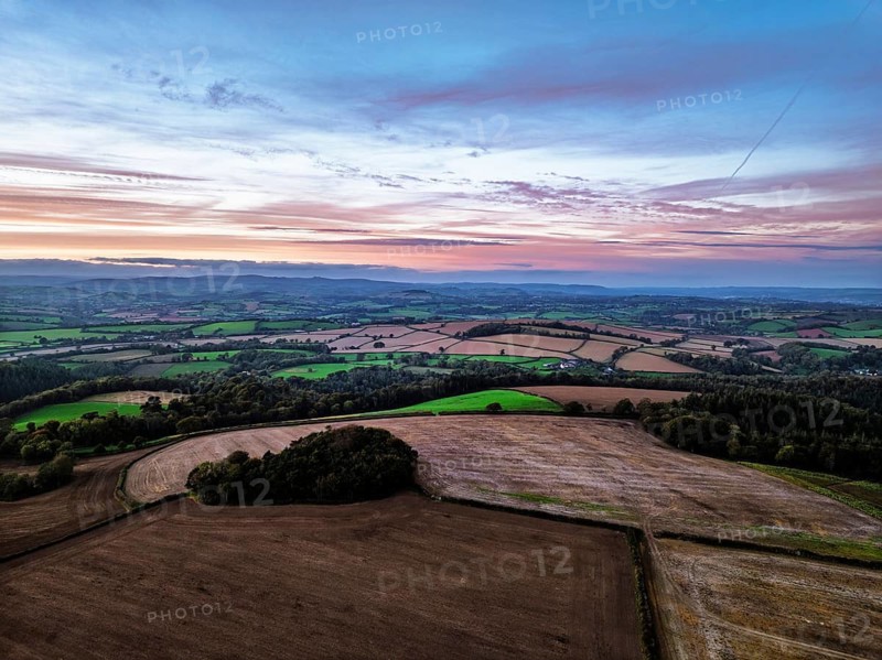 Sunset of Devon Farms and Fields over Berry Pomeroy from a drone, Totnes, England, United Kingdom